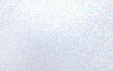 Light blue background decorative iridescent brilliance glitter. Winter holiday decorative blur texture. 