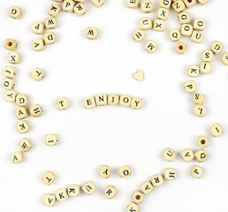 Lettering ENJOY with wooden beads