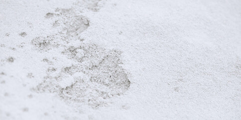 Obraz premium A step against snow background. footprint on white snow background.