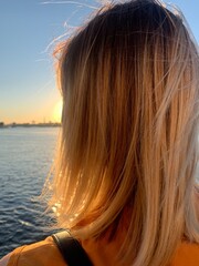 woman blonde hairs on the wind, sunset, natural