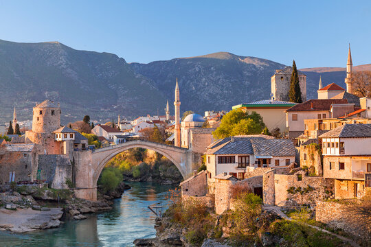Skyline of Mostar with the Mostar Bridge, houses and minarets, at the sunset in Bosnia and Herzegovina