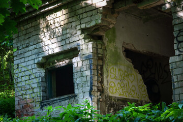 Fototapeta na wymiar Old abandoned white brick building with squared window holes