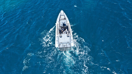 Aerial drone photo of luxury inflatable speed boat cruising in deep blue Aegean sea, Mykonos...
