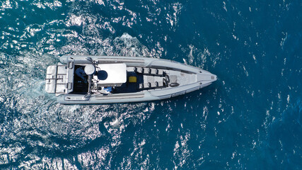 Aerial drone photo of luxury inflatable speed boat cruising in deep blue Aegean sea, Mykonos island, Cyclades, Greece