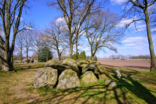 Megalithic dolmen graves in dutch landscape with fields and farms in background-In dutch it's called Hunebed,D28. Borger, Drenthe, The Netherlands.