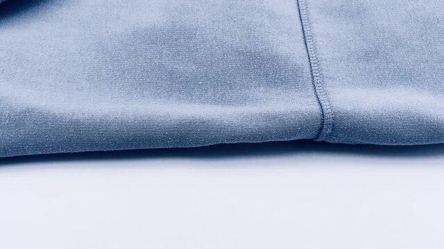close up camera panning on folded blue clothing