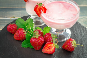 Ripe, fresh strawberries in a bowl on an old background.