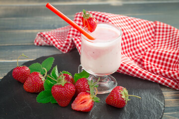 Sweet strawberry and healthy, wholesome food in composition on the table.
