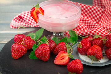 Sweet strawberry and healthy, wholesome food in composition on the table.