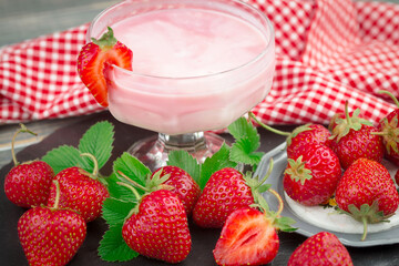Sweet strawberry and healthy, wholesome food in composition on the table.