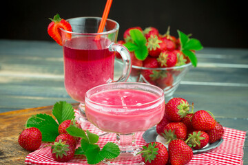 Ripe, fresh strawberries in a bowl on an old background.