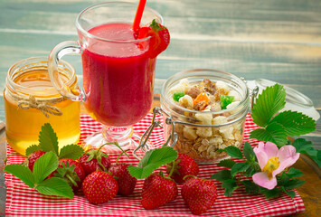 Sweet strawberry and healthy, wholesome food in composition on the table.