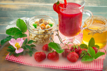 Sweet strawberry and healthy, wholesome food in composition on the table.