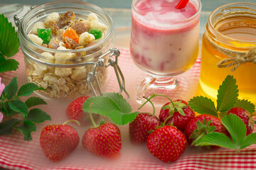 Sweet strawberry and healthy, wholesome food in composition on the table.