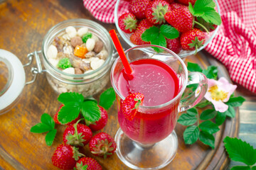 Ripe, fresh strawberries in a bowl on an old background.