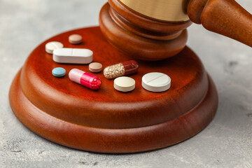 Judge gavel and pills. Law in medicine, prohibition of medicines