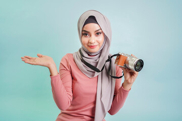 Muslim woman photographer with a digital camera. tourist holing camera and ready to press the shutter to capture the photo.