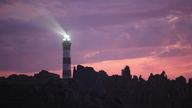 Creach lighthouse illuminated at dusk, the most powerful in the world, Ushant island, (aka Ouessant), Brittany, France