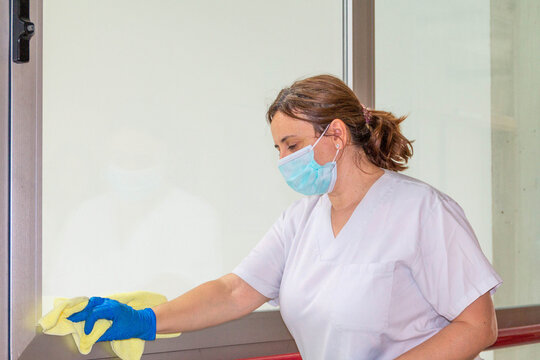 Woman Disinfecting Hospital With Mask And Protection Against Coronavirus COVID-19