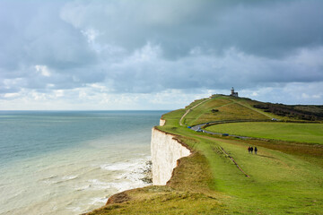 View of Birling Gap and cliffs in the South Downs national park on a cloudy day. The white cliffs of East Sussex, South East England, including Seven Sisters, are one of the landmarks of the UK