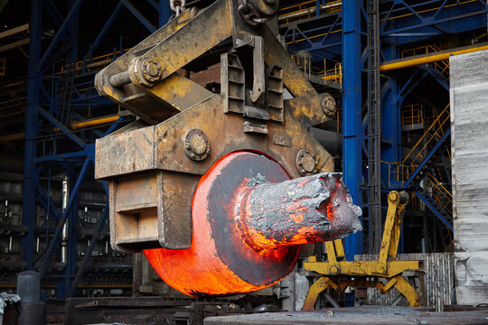 Press-Forging Shop. Transportation of a hot ingot for forging