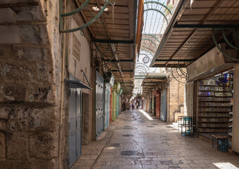 Christian quarter street passing through Arab Market with closed shops in the old city of Jerusalem, Israel