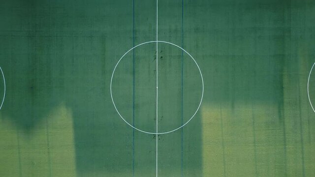 Aerial view of empty soccer field . Zoom out .