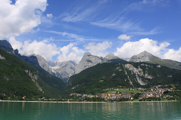 Fototapeta na wymiar Green and blue landscape of Molveno lake with some clouds