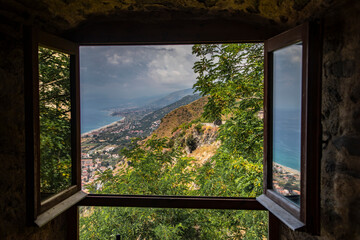 
window overlooking the mediterranean sea in the city of FiumeFreddo, Calabria, Italy