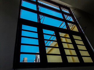 window in the sky.The blue sky behind the wooden windows in the old buildingThe blue sky behind the wooden windows in the old building