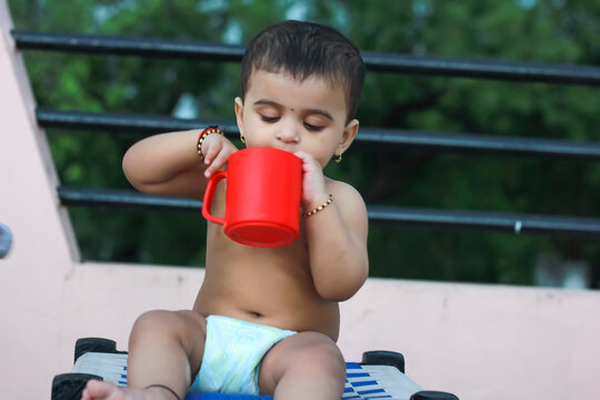 Indian Child Drinking Milk In Mug