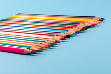 coloured pencils isolated on blue background