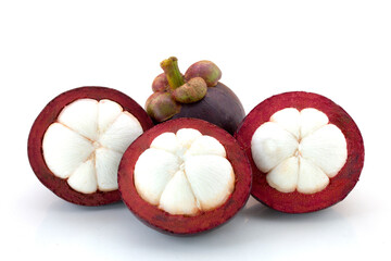 Ripe mangosteens (Garcinia mangostana) or half mangosteen with green leaves isolated on the white background.