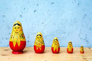 russian dolls on wooden table with grey background