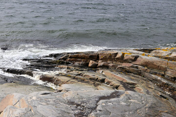 Granite rock sloping into the sea with nice patterns