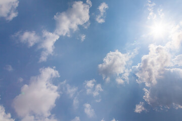 Beautiful light blue sky with cloud for background. the Cumulus cloud with the sun in midday.