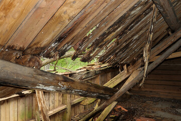 Caved in roof in an attic in a deserted house