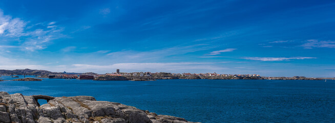 Panorama of swedish coastal landscape with rocky islands, blue water and blue sky