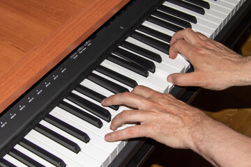 Fototapeta premium Two hands playing the piano