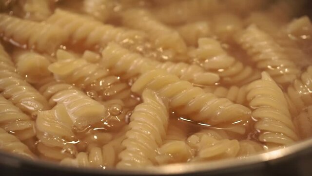 fusilli macaroni close up in boiling water