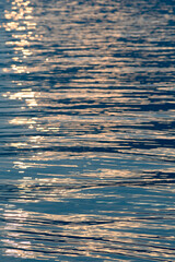 Sunset light reflecting on rippled water surface