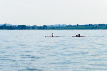 Two men canoeing on Lake Iseo in Italy