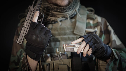 Soldier performing a tactical reload of pistol