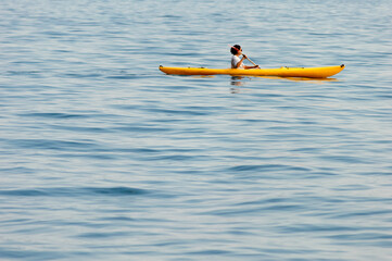 A person enjoys Kayaking in lake Iseo in Italy