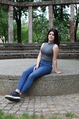 Young black-haired girl posing in the atrium