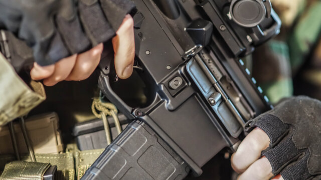 Abstract closeup of security contractor holding an AR15 Rifle