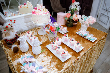 Decorating the festive table with cake and sweets