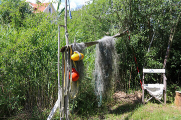 Fototapeta na wymiar Fishing net hanging to dry on land