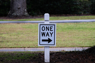 American one way sign with grass in the background