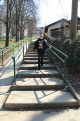 Black haired girl on the stairs in the park